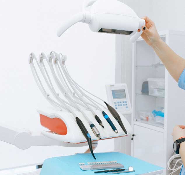 Dentist examining a patient’s teeth at Eshwary Dental
